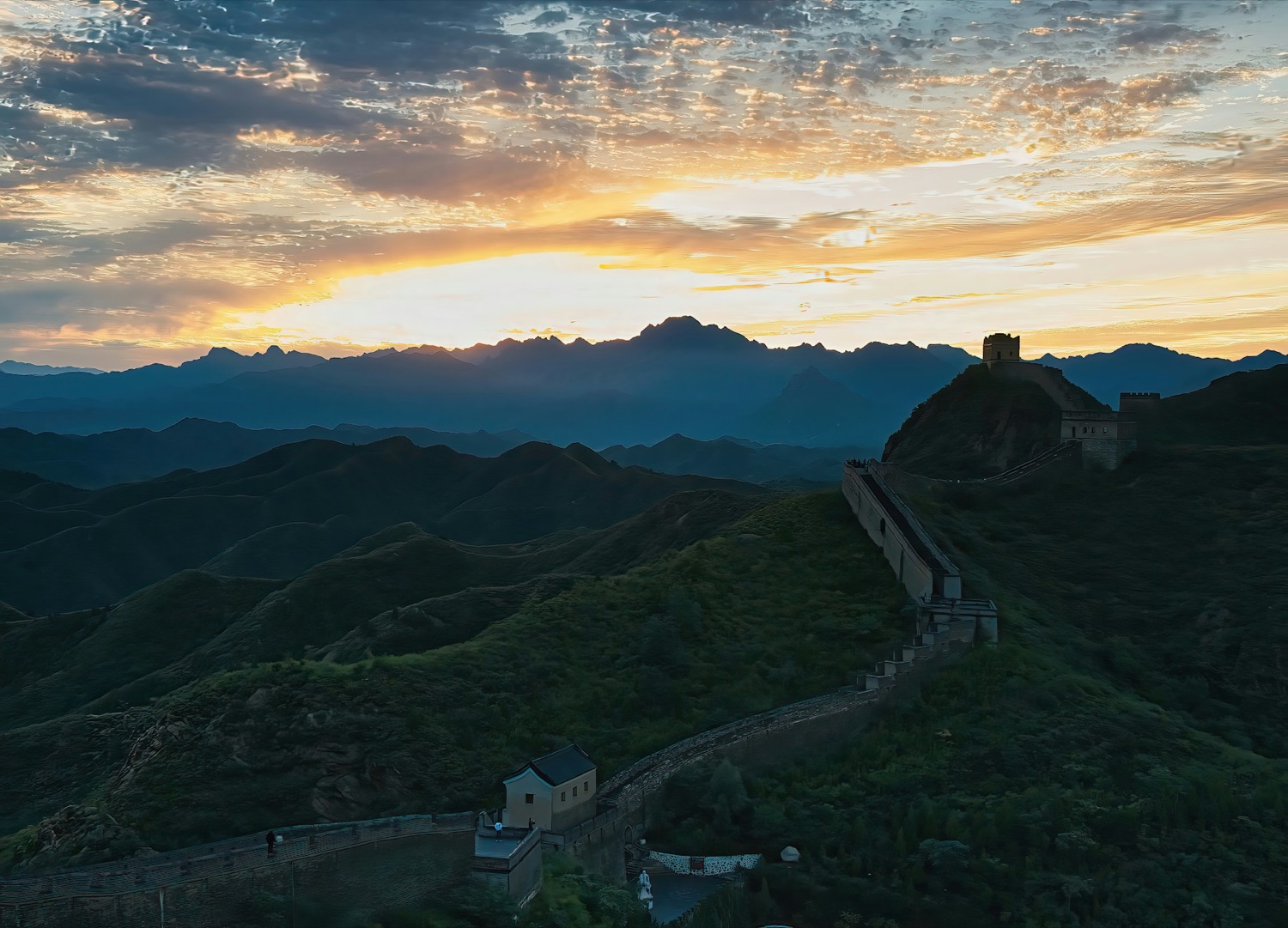The Great Wall crossing mountain ridges in early golden light